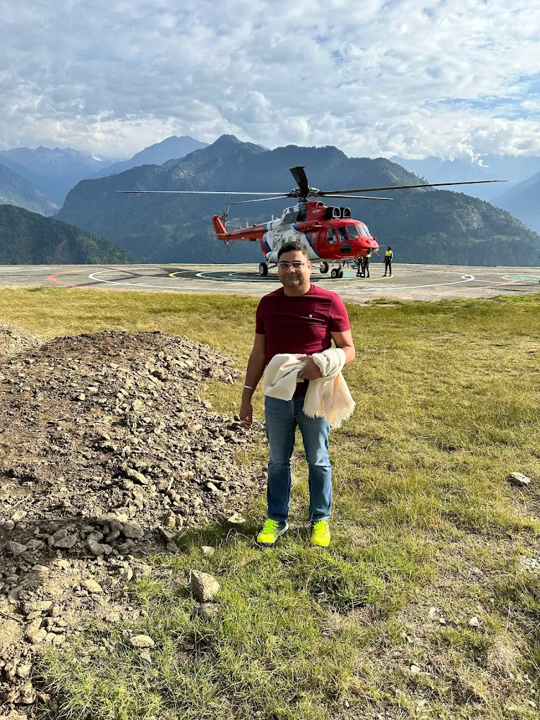 Traveller at the helipad with mountain backdrop