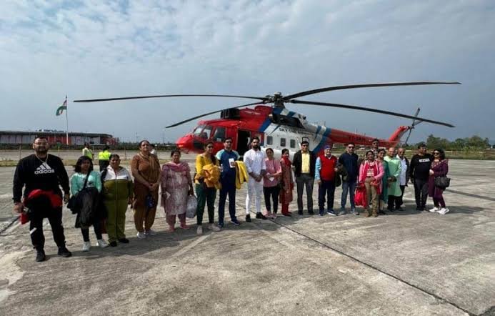 Large group with helicopter and Indian flag
